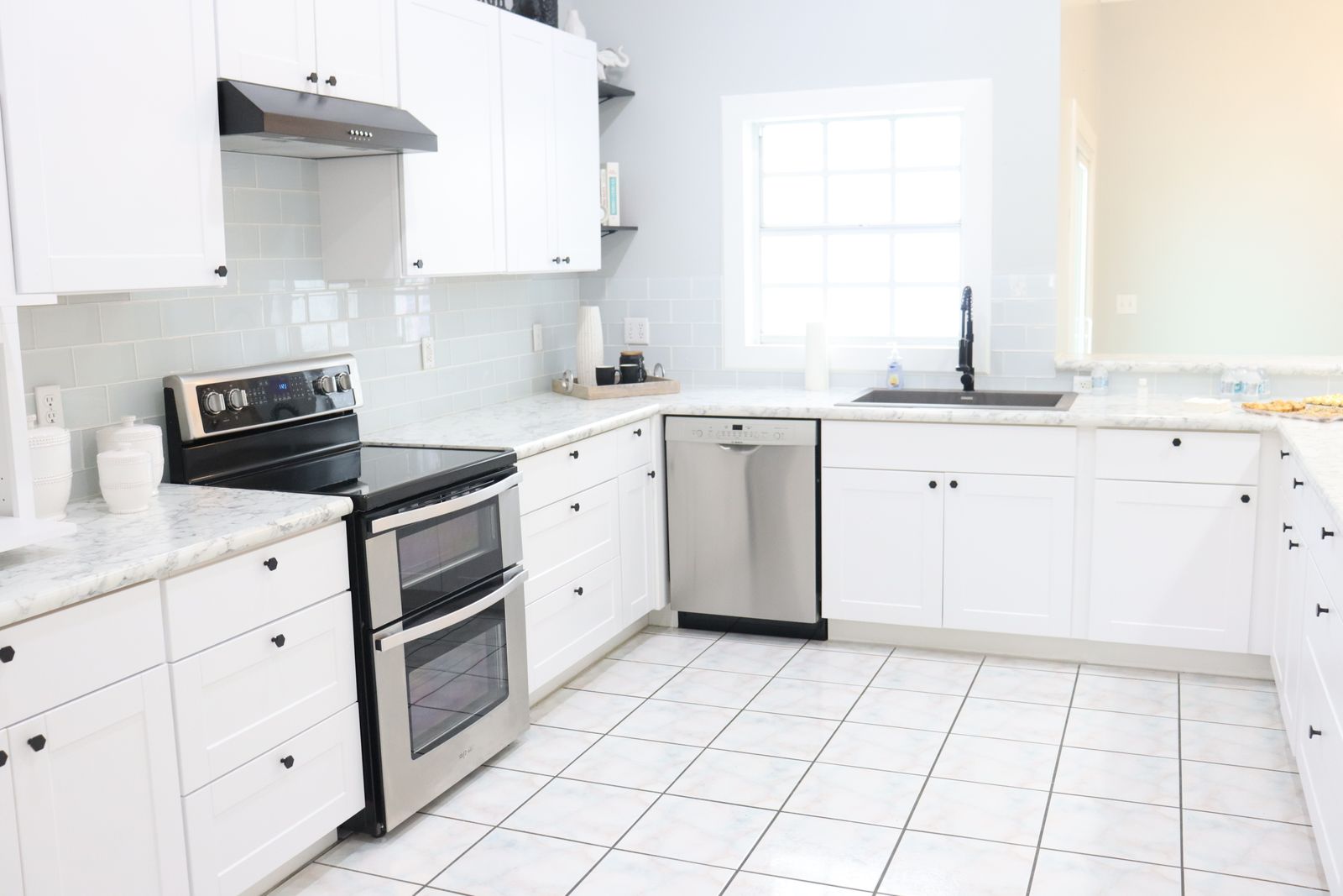 An open built-in dishwasher loaded with clean dishes — Viking dishwasher repair